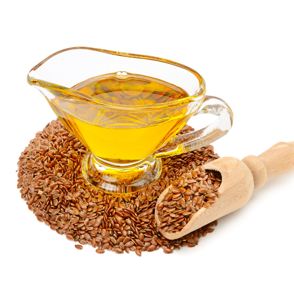 Pile of raw flaxseeds on a textured wooden surface, highlighting their omega-3-rich properties for stronger, healthier hair.